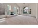 Bright living room featuring a fireplace, large windows, and neutral carpeting at 1312 Fragrant Spruce Ave, Las Vegas, NV 89123