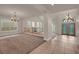 Open-concept living area with tile flooring and a decorative chandelier above the front door at 1312 Fragrant Spruce Ave, Las Vegas, NV 89123