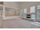 Open living space with high ceilings, fireplace, large windows, and a loft-like ambiance at 1312 Fragrant Spruce Ave, Las Vegas, NV 89123