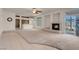 A spacious living room featuring tile and carpeted flooring, a fireplace, and a ceiling fan at 1312 Fragrant Spruce Ave, Las Vegas, NV 89123