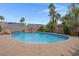Stunning in-ground pool with rock waterfall, lush landscaping, and solar panels in the background at 1312 Fragrant Spruce Ave, Las Vegas, NV 89123