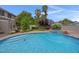 Sparkling in-ground pool and spa surrounded by beautiful landscaping and mature palm trees at 1312 Fragrant Spruce Ave, Las Vegas, NV 89123