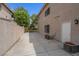 Concrete side yard with privacy wall, air conditioning units, and access door at 1312 Fragrant Spruce Ave, Las Vegas, NV 89123
