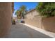View of the side yard featuring a concrete path, privacy wall, and palm trees at 1312 Fragrant Spruce Ave, Las Vegas, NV 89123