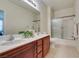 Bathroom featuring a double sink vanity, framed mirror, and glass-enclosed shower at 1370 Crystal Hill Ln # 3, Henderson, NV 89012