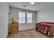 Cozy Bedroom with a wooden crib and dresser, creating a comforting space at 1370 Crystal Hill Ln # 3, Henderson, NV 89012