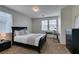 Bright bedroom featuring a black sleigh bed, modern desk, and neutral decor at 1370 Crystal Hill Ln # 3, Henderson, NV 89012