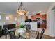 Charming dining area with a glass table, with adjacent kitchen and living spaces at 1370 Crystal Hill Ln # 3, Henderson, NV 89012