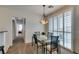 Bright dining room with glass table and pendant lighting at 1370 Crystal Hill Ln # 3, Henderson, NV 89012