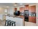 Charming kitchen featuring granite countertops, modern black appliances, and wooden cabinets at 1370 Crystal Hill Ln # 3, Henderson, NV 89012