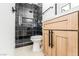 Bathroom featuring modern light wood vanity, toilet and tiled shower at 1415 Helen Ave, North Las Vegas, NV 89030