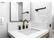 Updated bathroom features modern sink with gold hardware and bright vanity lighting at 1415 Helen Ave, North Las Vegas, NV 89030