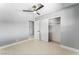 Bright bedroom featuring light gray walls, a ceiling fan and a closet at 1415 Helen Ave, North Las Vegas, NV 89030