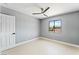 Bright bedroom with light gray walls, wood-look floors and a window at 1415 Helen Ave, North Las Vegas, NV 89030