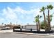 Palm trees and a black iron fence complement the exterior at 1415 Helen Ave, North Las Vegas, NV 89030