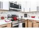 Close up of kitchen with modern stainless steel appliances and wood cabinets, and decorated countertops at 1415 Helen Ave, North Las Vegas, NV 89030