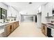 Bright kitchen offers open layout to living area, featuring white cabinets and modern stainless steel appliances at 1415 Helen Ave, North Las Vegas, NV 89030