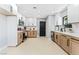 Bright kitchen featuring white and wood cabinets, stainless steel appliances, and light wood-look floors at 1415 Helen Ave, North Las Vegas, NV 89030