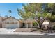 Charming single-story home with a two-car garage, desert landscaping, and mature shade tree at 1502 Cliff Branch Dr, Henderson, NV 89014