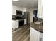 Modern kitchen with stainless steel appliances, granite countertops, and white cabinets at 1502 Cliff Branch Dr, Henderson, NV 89014