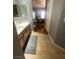 This is an ensuite bathroom with a tile floor and hardwood floors beyond at 1511 Cardinal Peak Ln # 201, Las Vegas, NV 89144