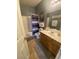 Well-lit bathroom with tile floors, wooden cabinets, framed mirror, and shower with curtain at 1511 Cardinal Peak Ln # 201, Las Vegas, NV 89144