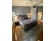 Well-lit bedroom with wood floors, plush rug, tufted headboard, nightstands and modern decor at 1511 Cardinal Peak Ln # 201, Las Vegas, NV 89144