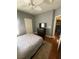 Bedroom with wood floors, ceiling fan and a rug with a TV on top of a dark dresser at 1511 Cardinal Peak Ln # 201, Las Vegas, NV 89144