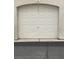 Garage door of a one car garage with white square paneling at 1511 Cardinal Peak Ln # 201, Las Vegas, NV 89144