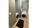 Laundry area equipped with white appliances, a dark rug and neutral walls at 1511 Cardinal Peak Ln # 201, Las Vegas, NV 89144
