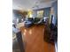 Open-concept living room featuring modern decor, laminate flooring, and seamless flow to the kitchen at 1511 Cardinal Peak Ln # 201, Las Vegas, NV 89144