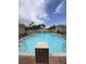 Community pool surrounded by fencing and lounge chairs at 1511 Cardinal Peak Ln # 201, Las Vegas, NV 89144