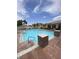 Community pool featuring a bright blue pool with surrounding lounge chairs and lush landscaping at 1511 Cardinal Peak Ln # 201, Las Vegas, NV 89144