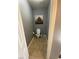 This powder room has a toilet, tile floor, and gray paint at 1511 Cardinal Peak Ln # 201, Las Vegas, NV 89144