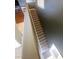 View of staircase leading upstairs with wood railings and neutral carpet at 1511 Cardinal Peak Ln # 201, Las Vegas, NV 89144