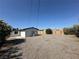 Expansive backyard offering ample space and featuring a mix of gravel and wooden fencing at 1600 E Mcdonald Ave, North Las Vegas, NV 89030