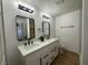 Bright bathroom with dual vanity, contemporary mirrors, modern lighting, and a sleek, minimalist design at 1600 E Mcdonald Ave, North Las Vegas, NV 89030