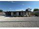 Charming single-story home with a low maintenance gravel yard, carport, and welcoming entrance at 1600 E Mcdonald Ave, North Las Vegas, NV 89030
