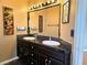 Bathroom features a double vanity with stylish black tile and framed mirrors at 1628 Palmae Way, Las Vegas, NV 89128