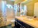 Bright bathroom features a shower over tub, and a decorative half moon window at 1628 Palmae Way, Las Vegas, NV 89128