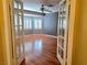 The home includes a bedroom with hardwood flooring, windows, and paneled french doors at 1628 Palmae Way, Las Vegas, NV 89128