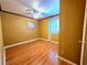 Cozy bedroom with hardwood floors, ceiling fan, and bright window at 1628 Palmae Way, Las Vegas, NV 89128