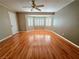 Bright bedroom boasts hardwood floors and a large bay window with plantation shutters at 1628 Palmae Way, Las Vegas, NV 89128