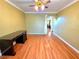 Bedroom has wood floors and ceiling fan, with lots of sunlight streaming in from the window at 1628 Palmae Way, Las Vegas, NV 89128