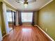 Bedroom features hardwood floors, closet with mirrored doors, and a window at 1628 Palmae Way, Las Vegas, NV 89128