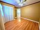 Bedroom featuring hardwood floors, a ceiling fan, and a double door closet at 1628 Palmae Way, Las Vegas, NV 89128