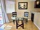 Cozy dining area with glass table and chairs next to sliding glass door at 1628 Palmae Way, Las Vegas, NV 89128