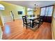 Dining area with wood floors, an adjacent living room, and staircase to the second floor at 1628 Palmae Way, Las Vegas, NV 89128
