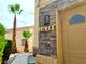 Charming front door with stone accents, desert landscaping, and visible house numbers at 1628 Palmae Way, Las Vegas, NV 89128