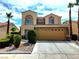 Two-story home boasting a two-car garage, desert landscaping, and a classic Southwest design at 1628 Palmae Way, Las Vegas, NV 89128
